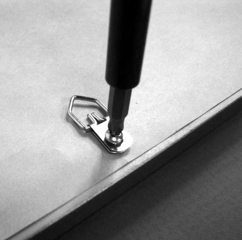 Figure CC-4: Attach a strap hanger with a screwdriver.
