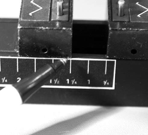 Figure J-5: Adjust the V-nail blocks to the measurement<br />determined on the set block scale.