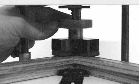 Figure J-6: Release the clamp locking screw (not shown) and<br />adjust the foot until it contacts the moulding.